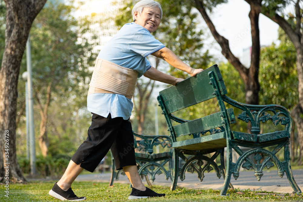 Happy smiling asian old woman exercising by stretching the leg muscles,workout,immunization,healthy female senior have strong knee and bones,health care,body balance,good healthy lifestyle of elderly Happy smiling asian old woman exercising by stretching the leg muscles,workout,immunization,healthy female senior have strong knee and bones,health care,body balance,good healthy lifestyle of elderly