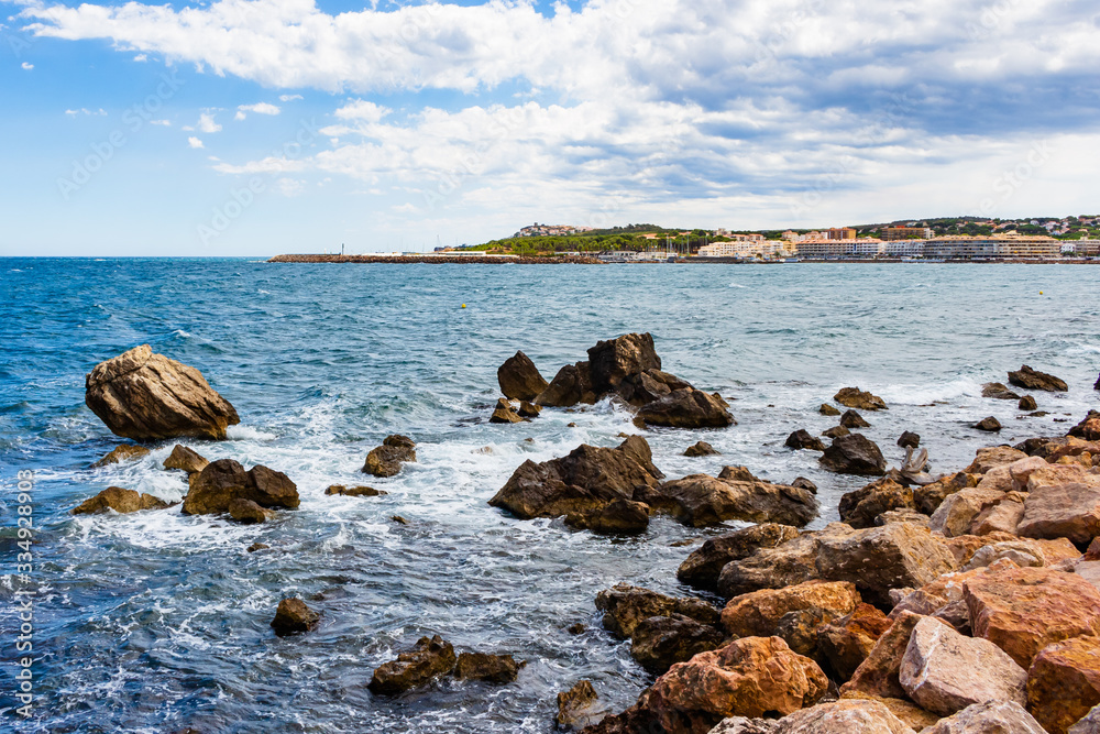 View from the shore of the Paseo Maritimo of La Escala the port in the background. Costa Brava, Catalonia, Spain
