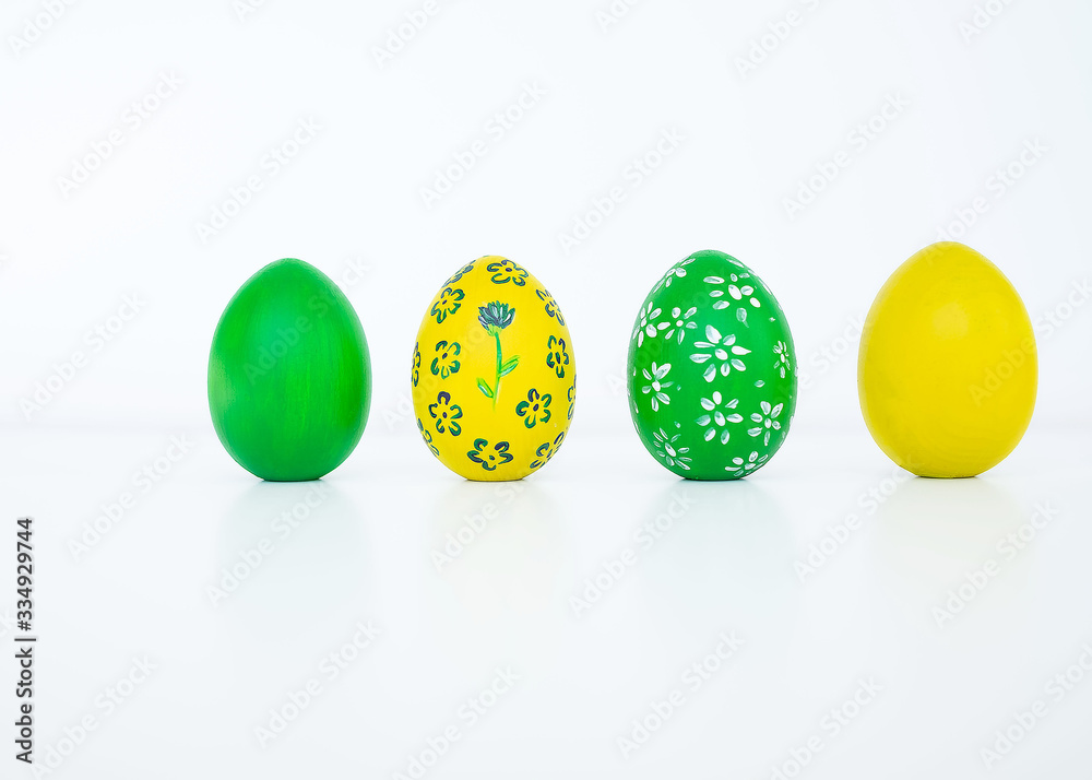 The concept of celebrating Easter. Colored and flower pattern painted eggs on white background. Copy space. Isolated. Close up The concept of celebrating Easter. Colored and flower pattern painted eggs on white background. Copy space. Isolated. Close up
