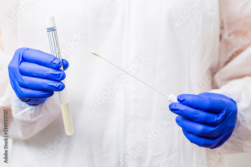 Doctor holding swab test tube for 2019-nCoV analyzing. Coronavirus test.