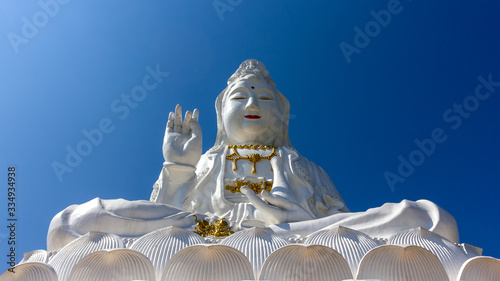 Great  Bodhisattva Guan Yin Statue Large statue but Realistic proportion with Clear sky at Wat huay pla kang temple, Chiangrai,Thailand. photo