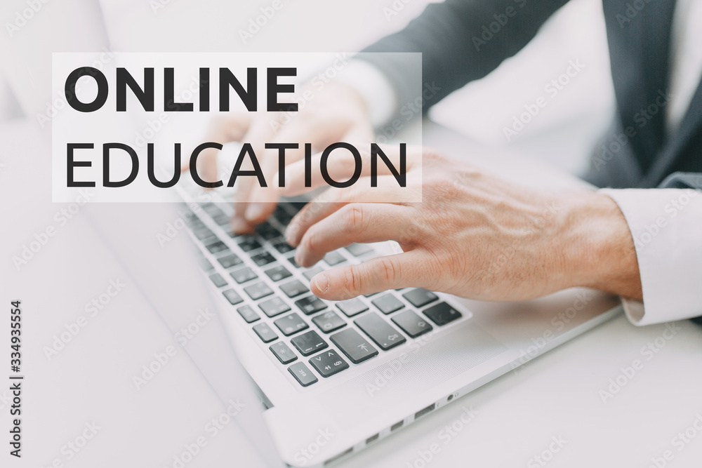 Work from home during quarantine. Hands at work on a laptop with bokeh. Online education on the Internet. Work from home during quarantine. Hands at work on a laptop with bokeh. Online education on the Internet.