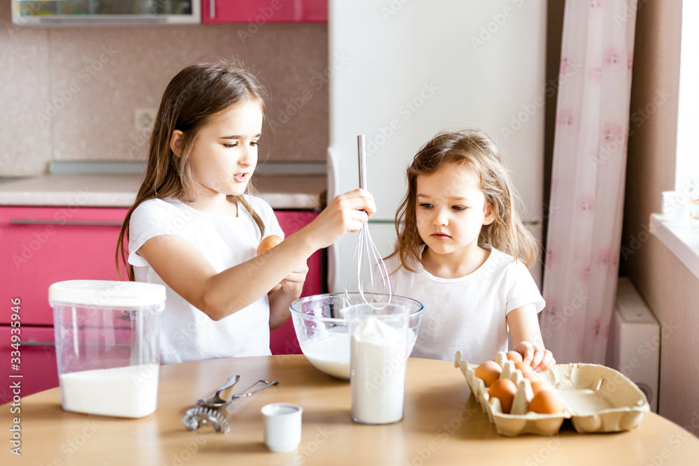 Sisters prepare Breakfast, pastries, mix flour, milk, eggs, pancakes in a bowl, children help mother, family Breakfast, cooking Sisters prepare Breakfast, pastries, mix flour, milk, eggs, pancakes in a bowl, children help mother, family Breakfast, cooking