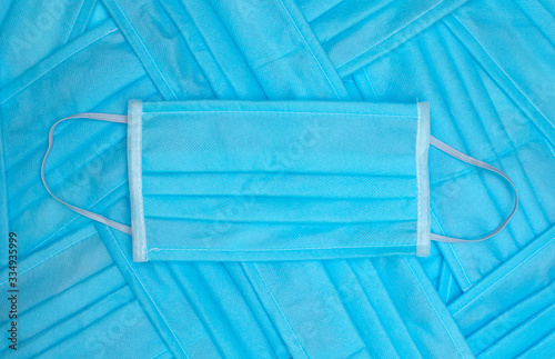 Many folded blue protective masks