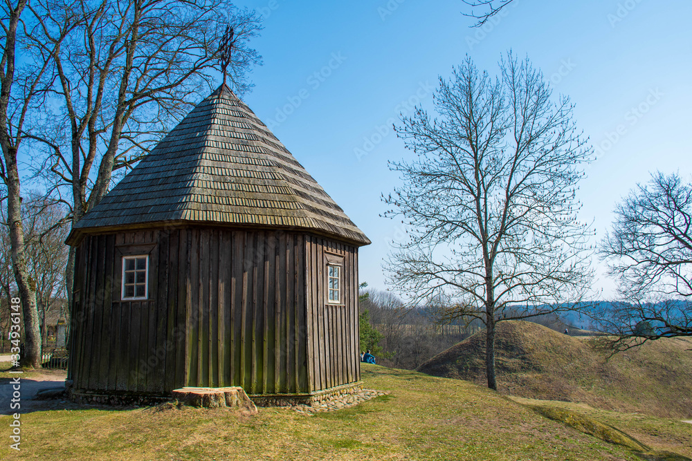 Obraz premium Hills of Kernave, Lithuania, UNESCO world heritage, was a medieval capital of the Grand Duchy of Lithuania, today is a tourist attraction and an archaeological site. Old wooden chapel 