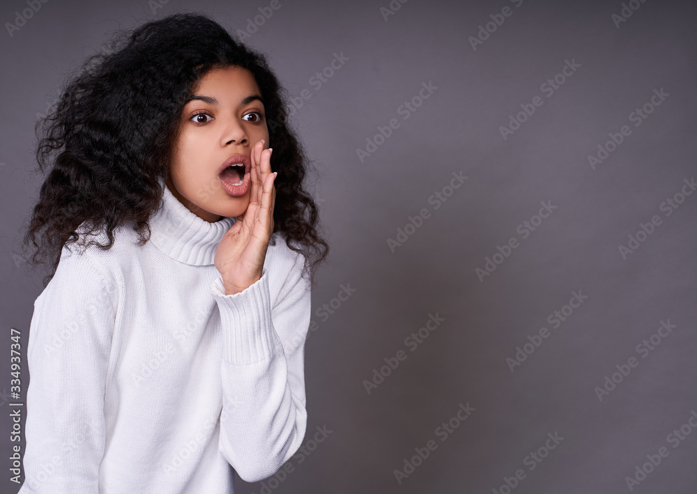 Screaming young african woman with hand at mouth. Screaming young african woman with hand at mouth.