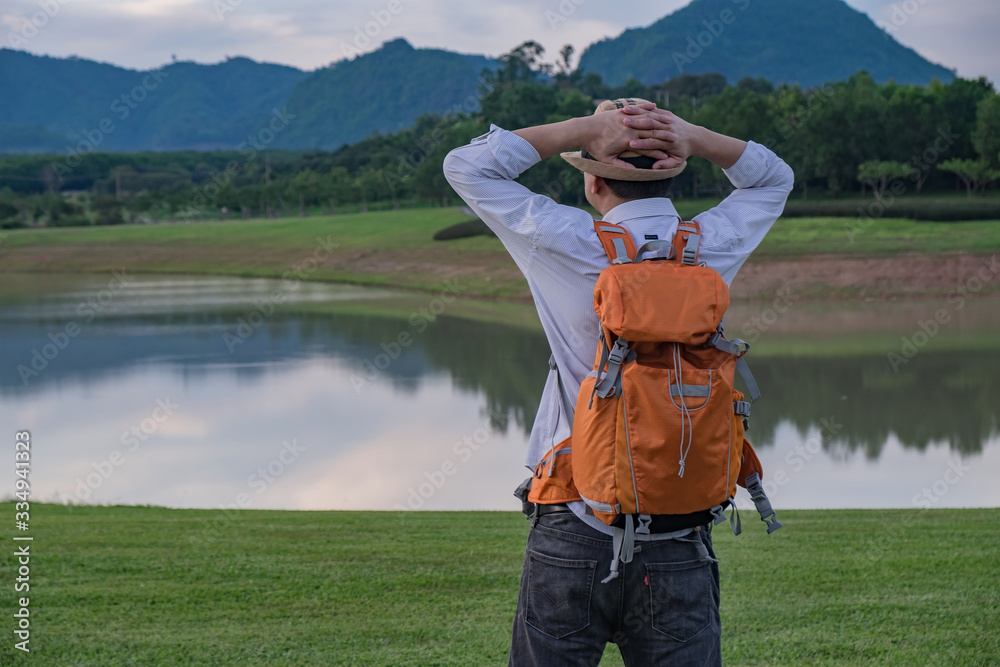 happy man with backpack on the top