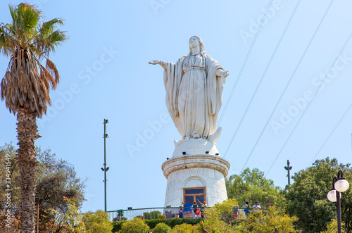 Santiago, Chile, Statue of the virgin Mary on San Cristobal hill. The snow-white statue of the Holy virgin Mary, considered the patroness of the townspeople, stands on the very top of the cliff, the 
