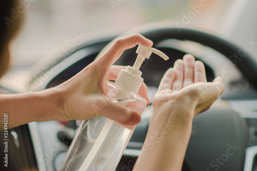 Alcohol gel hand washing and cleaning for Corona virus prevention in car,Alcohol 70% © Suriyo