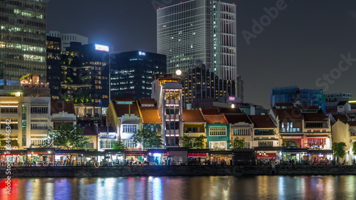 Singapore quay with tall skyscrapers in the central business district on Boat Quay night timelapse hyperlapse photo