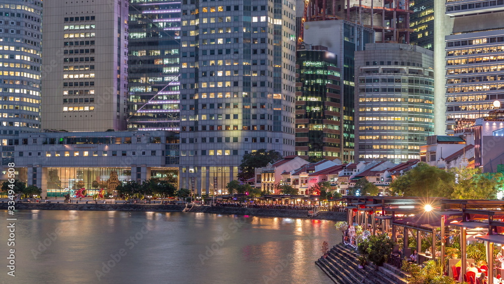 Singapore quay with tall skyscrapers in the central business district on Boat Quay day to night timelapse