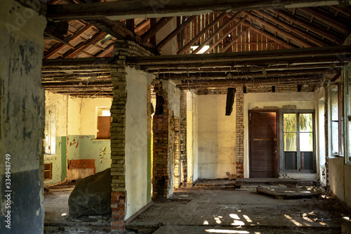 Old abandoned soviet military barrack building in ruins. House interior with broken floor and walls.