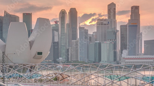 Photography Aerial view of sunset over Helix Bridge and Bayfront Avenue with traffic timelap