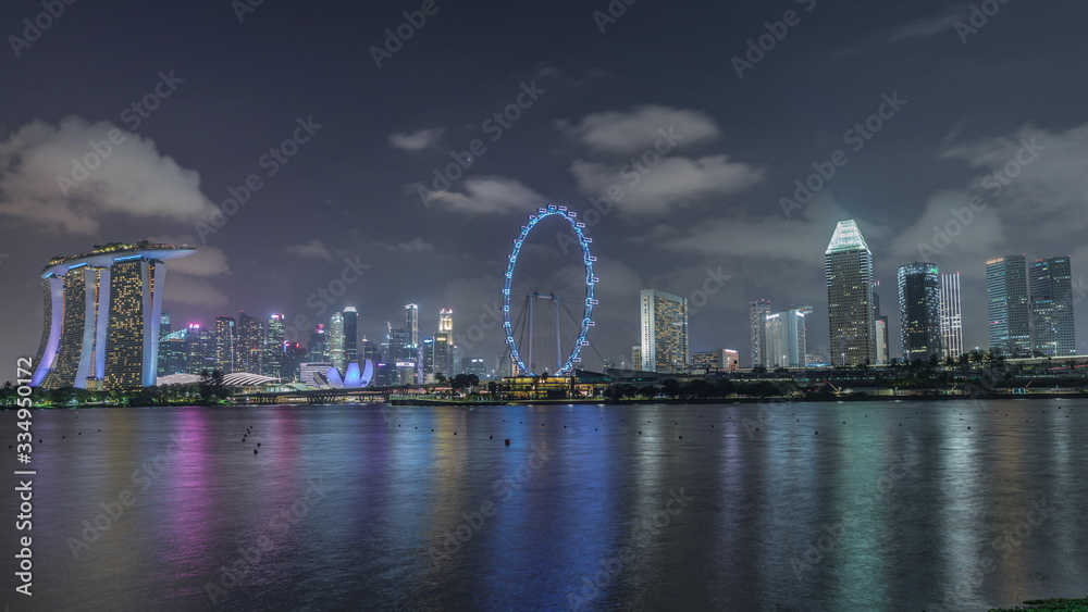 Downtown skyline of Singapore as viewed from across the water from The Garden East night timelapse. Singapore.