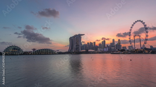 Downtown skyline of Singapore as viewed from across the water from The Garden East day to night timelapse. Singapore. © neiezhmakov
