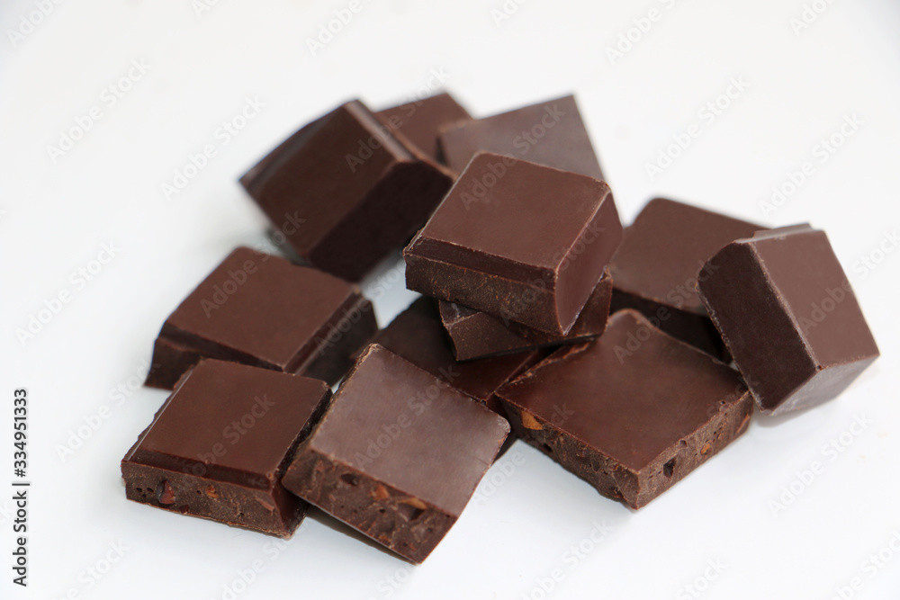 A pile of milk chocolate slab blocks broken up and stacked A pile of milk chocolate slab blocks broken up and stacked
