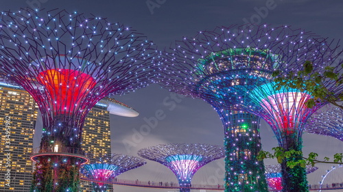 Futuristic aerial view of amazing illumination at Garden by the Bay day to night timelapse in Singapore.