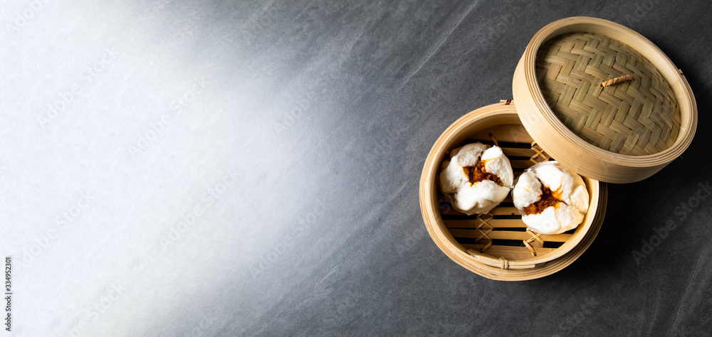 肉まん. steamed pork bun. Chinese Traditional cuisine concept. Dumplings Dim Sum in bamboo steamer with text copy space. Asian food background 肉まん. steamed pork bun. Chinese Traditional cuisine concept. Dumplings Dim Sum in bamboo steamer with text copy space. Asian food background