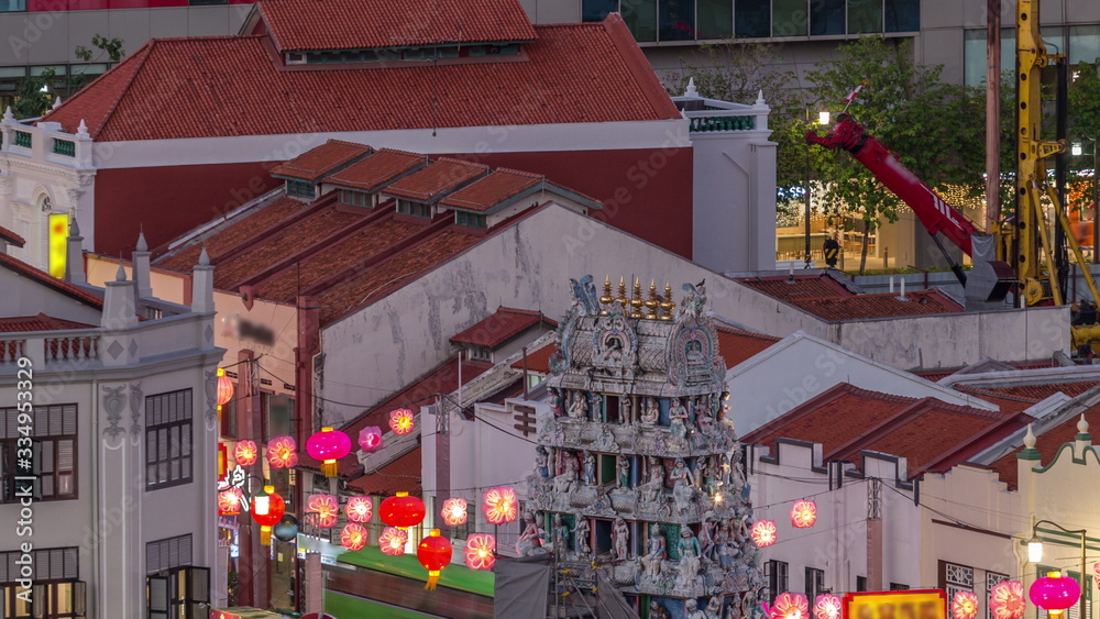 Old houses in Chinatown with Details of the decorations on the roof of the Sri Mariamman Hindu temple aerial day to night timelapse, Singapore