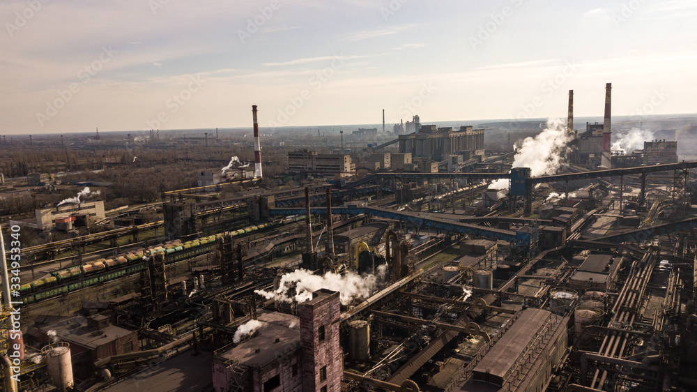 Steel ecology metallurgical iron plant smokes from pollution of industry pipes. View from the drone.