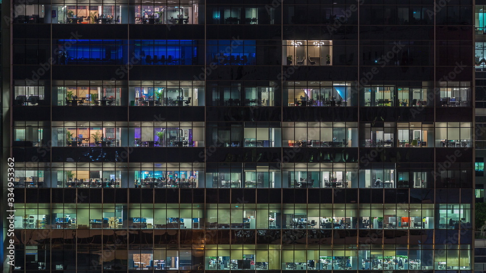 Modern office building with big windows at night timelapse, in windows light shines Modern office building with big windows at night timelapse, in windows light shines