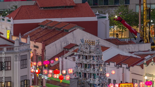 Old houses in Chinatown with Details of the decorations on the roof of the Sri Mariamman Hindu temple aerial day to night timelapse, Singapore