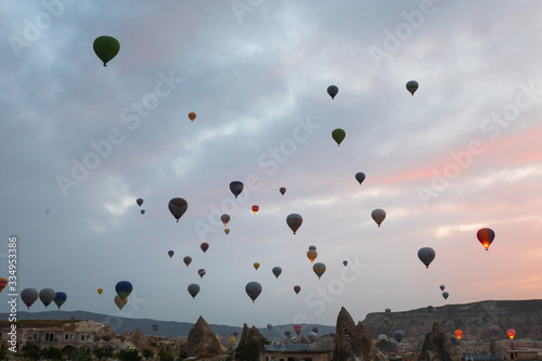 Baloons on the sky and typical Cappadocian landscape, close to Goreme. Nevsehir, Anatolia, Turkey