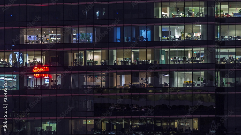 Modern office building with big windows at night timelapse, in windows light shines Modern office building with big windows at night timelapse, in windows light shines