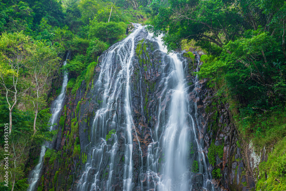 Efrata waterfall in the rainforest highlands near Lake Toba in Sumatra, travel destination, Indonesia. Long exposure water flowing effect.