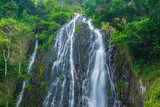 Efrata waterfall in the rainforest highlands near Lake Toba in Sumatra, travel destination, Indonesia. Long exposure water flowing effect.