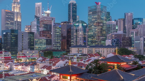 Photography The Buddha Tooth Relic Temple comes alive at night in Singapore Chinatown day to night timelapse, with the city skyline in the background