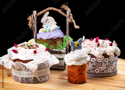 Easter composition with orthodox sweet bread, kulich and eggs on dark background.