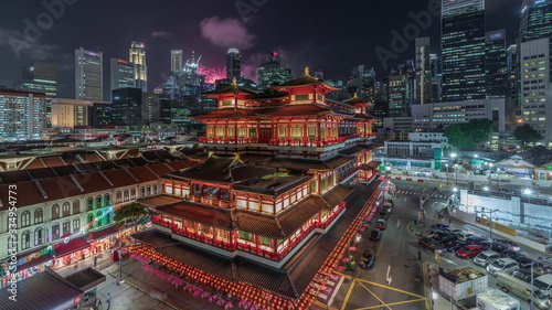 Photography The Buddha Tooth Relic Temple comes alive at night timelapse in Singapore Chinatown, with the city skyline in the background