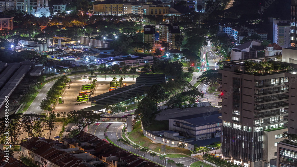 Aerial view to busy bus terminal in Singapore night timelapse.