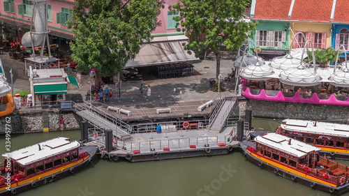 Tourist boats docking at Clarke Quay habour aerial timelapse.