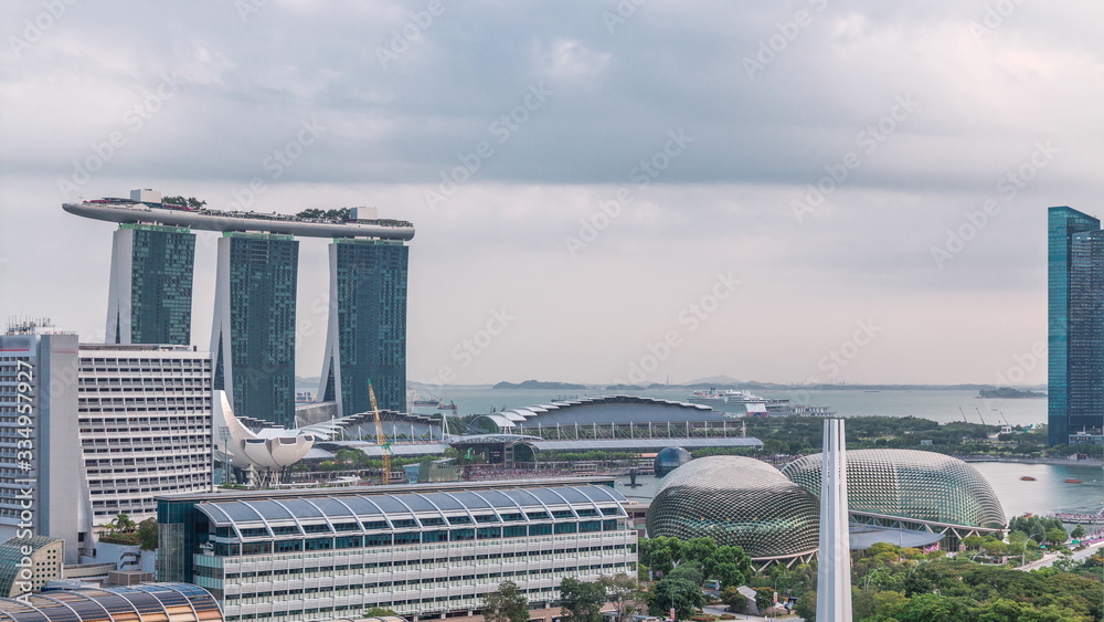 Evening panorama with Marina Bay area and skyscrapers city skyline aerial timelapse.