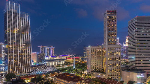 Evening panorama with Marina Bay area and skyscrapers city skyline aerial day to night timelapse.