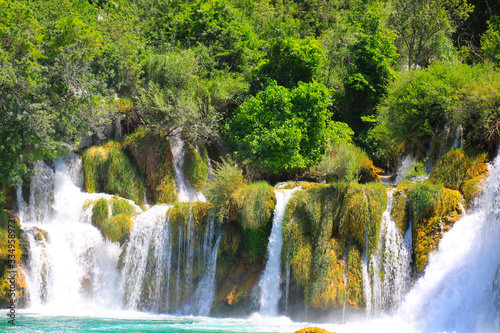 A picturesque cascade waterfall among large stones in the Krka Landscape Park  Croatia in spring or summer. The best big beautiful Croatian waterfalls  mountains and nature.