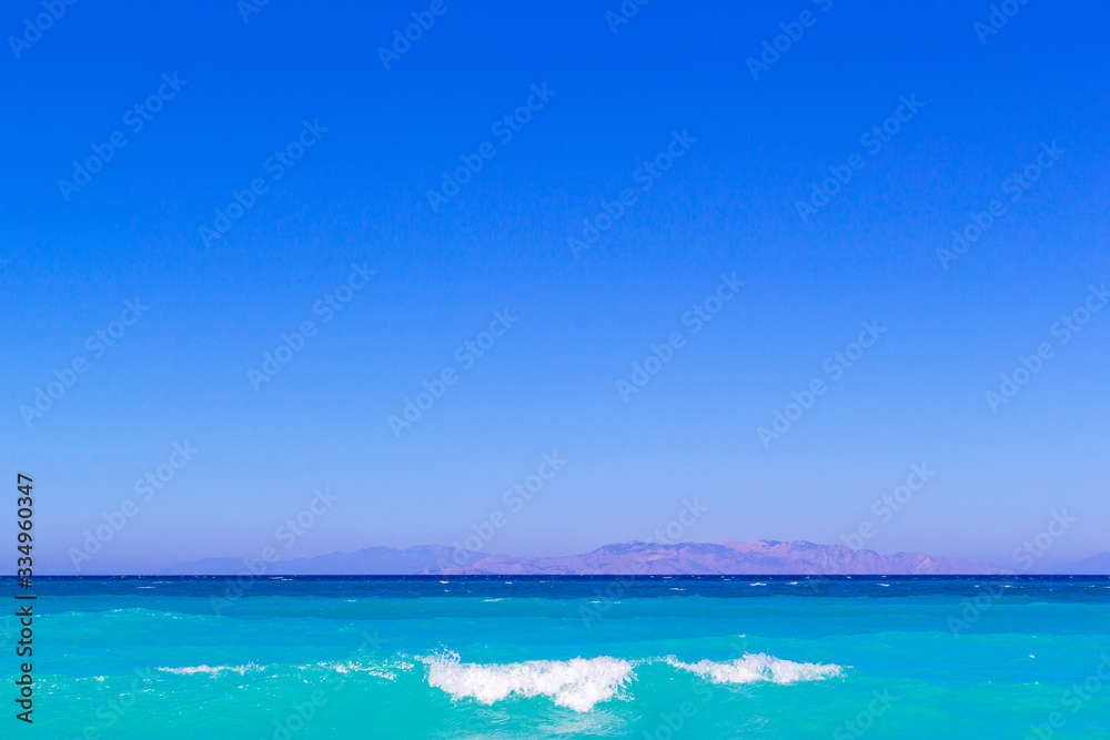 simply landscape with sea turquoise color , mountains on the horizon and gradient blue sky.Horizon line between calm mediterranean sea and clear blue sky