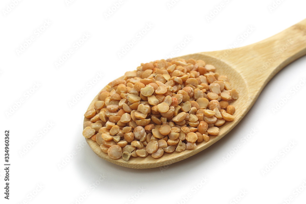 Wooden spoon with small peas on a white background Wooden spoon with small peas on a white background