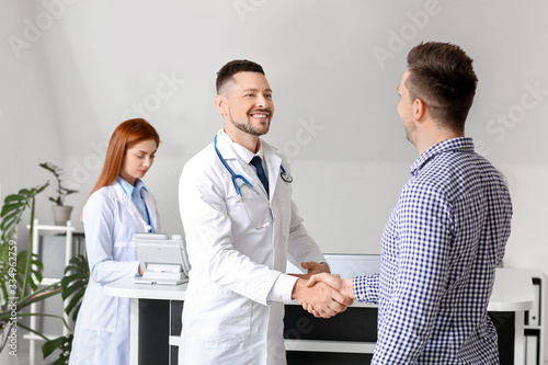 Male doctor and patient sha...