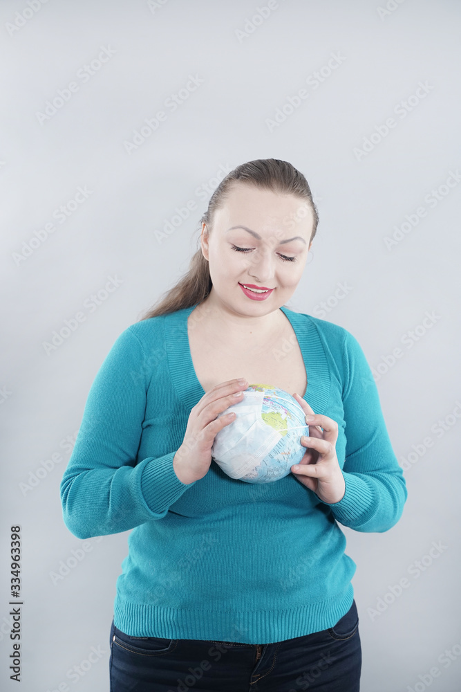 Global Flu Pandemic Concept. Woman with world globe With Medical Mask on white studio background. Global Flu Pandemic Concept. Woman with world globe With Medical Mask on white studio background.
