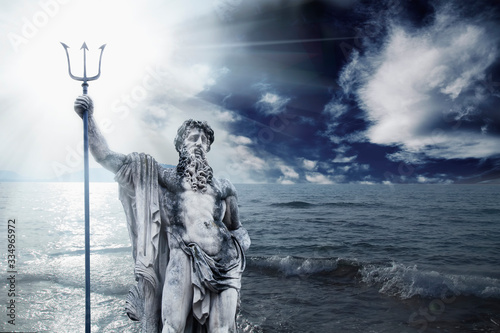 The mighty god of the sea and oceans Neptune (Poseidon). The ancient stone statue against dramatic sea landscape.