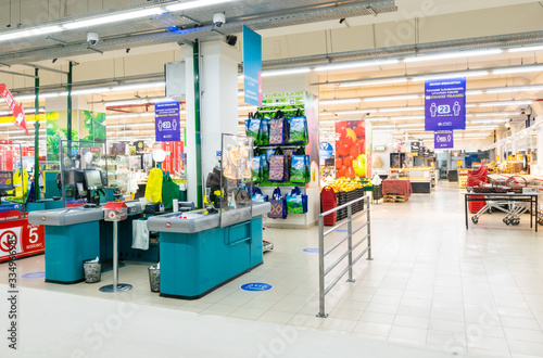 Cash desks with protective transparent shields in shop facility of Carrefour with no people around. New safety rules and changes in food industry concept.01.04.2020 photo