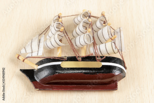 
Sailing ship as a souvenir, delicate work, photographed on a light wooden background.