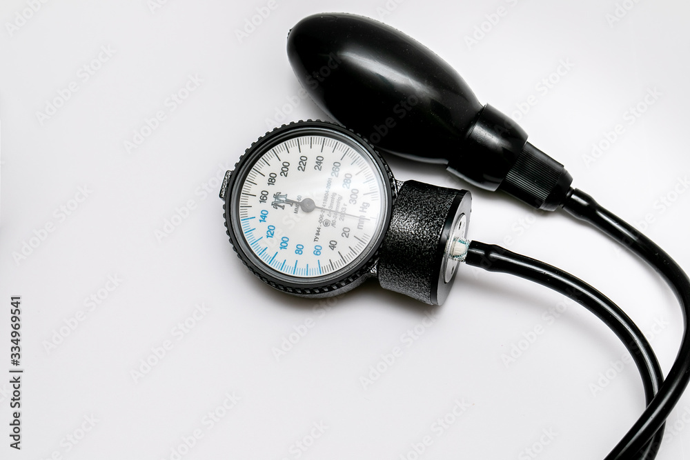 The black tonometer lies on a white background. View from above. Close-up The black tonometer lies on a white background. View from above. Close-up