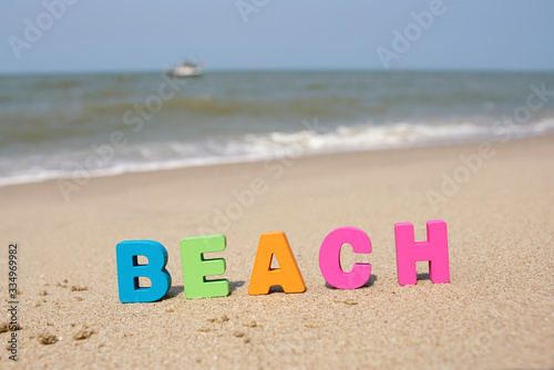Colorful Letters ‘ BEACH’ on sandy beach, Let's enjoy holiday in summer season 