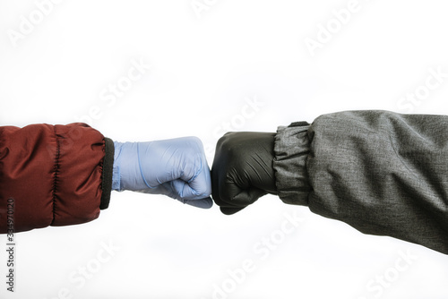 fist bump in gloves for protection from coronavirus covid-19