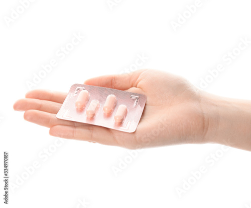 Female hand with pills on white background