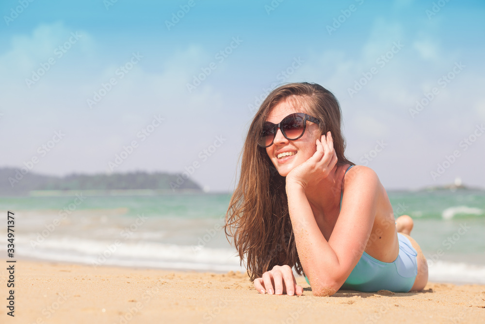 Young female enjoying sunny day on tropical beach Young female enjoying sunny day on tropical beach
